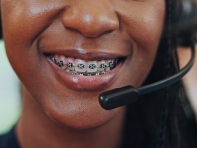 employee woman with a headphone wearing a braces