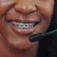 employee woman with a headphone wearing a braces