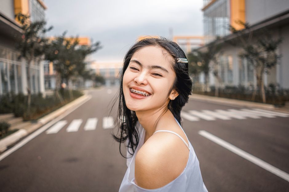 adult with braces smiling in Bakersfield