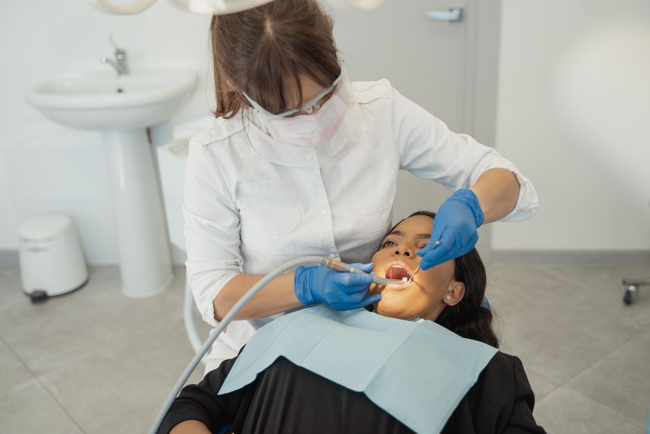 dentist examining a patient's teeth to check readiness for braces in Bakersfield