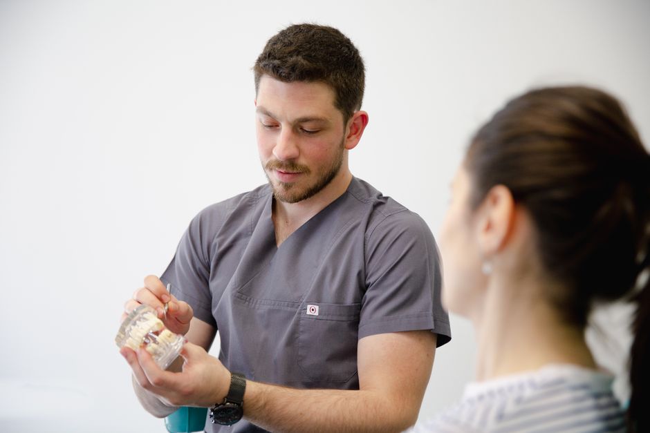 dentist reviewing a patient's bite with a dental model during a Bakersfield consultation