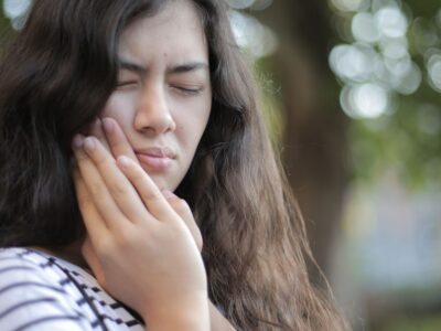 person with jaw and facial pain considering TMJ treatment in Bakersfield