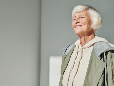 senior woman smiling confidently after getting affordable dentures in Bakersfield