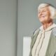 senior woman smiling confidently after getting affordable dentures in Bakersfield